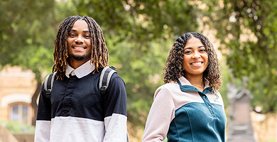 Two smiling Austin Community College students outdoors on campus