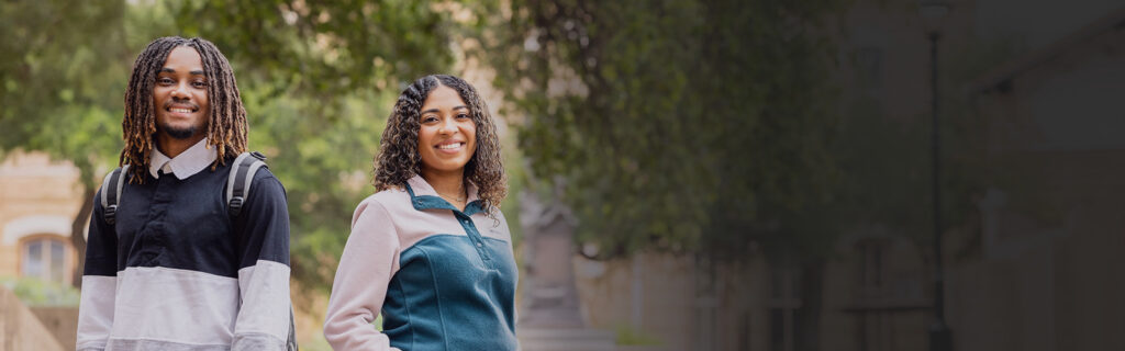 Two smiling Austin Community College students outdoors on campus